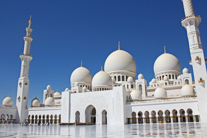 Experience the stunning white marble elegance of Sheikh Zayed Mosque where architectural beauty meets serene spirituality perfectly paired with the excitement of Ferrari World in Abu Dhabi.